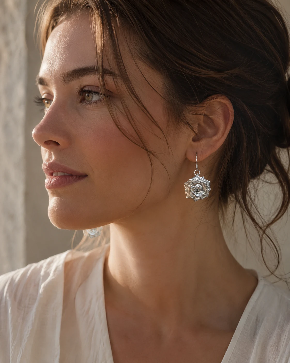 Handcrafted silver earring worn in profile