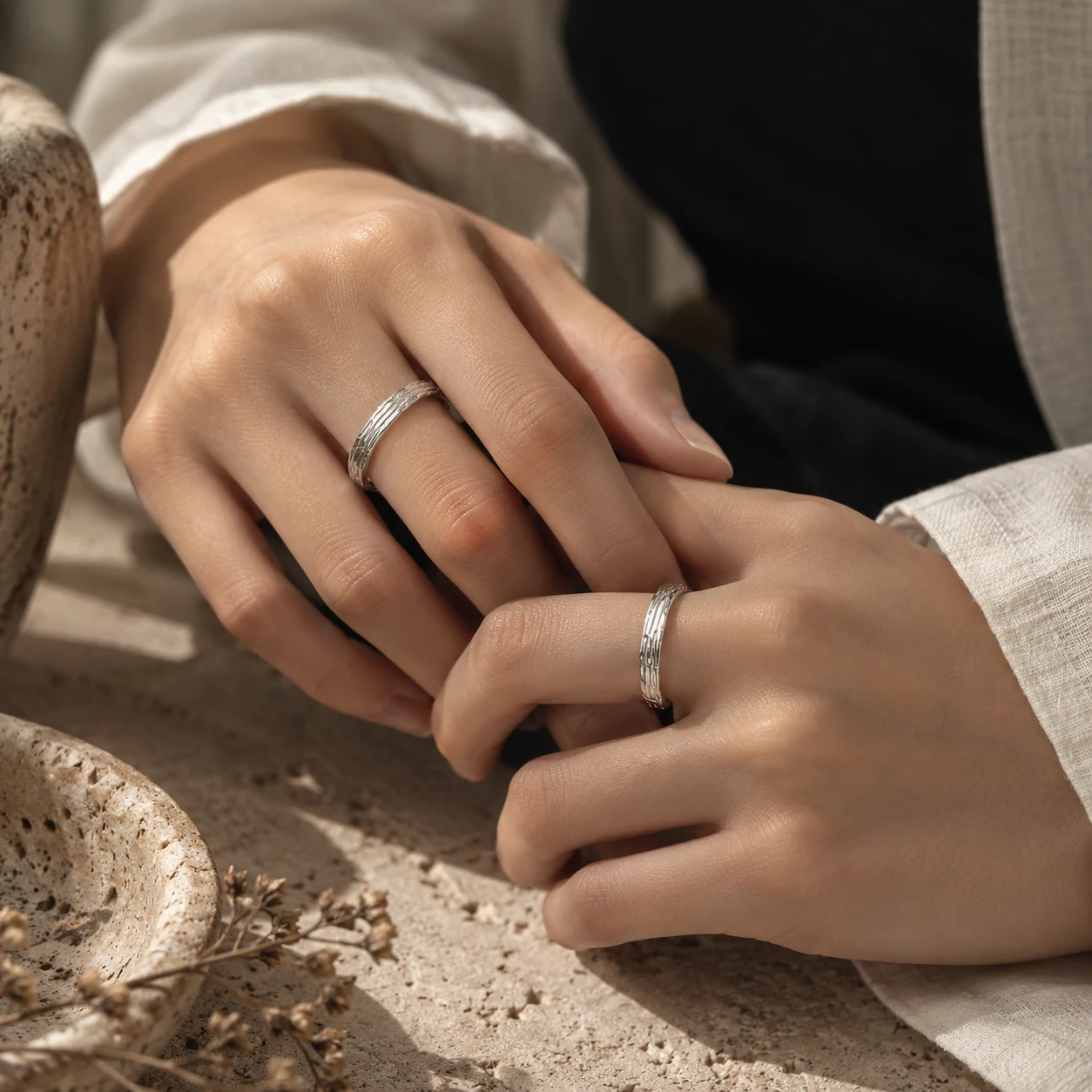 Sculptural silver rings worn on a hand
