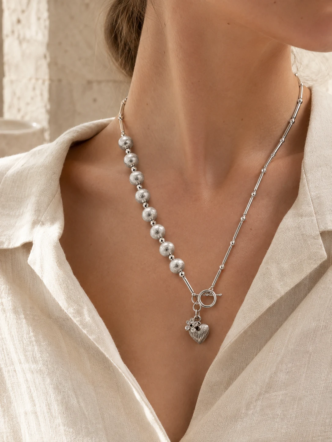 One-of-a-kind custom silver necklace worn at the collarbone